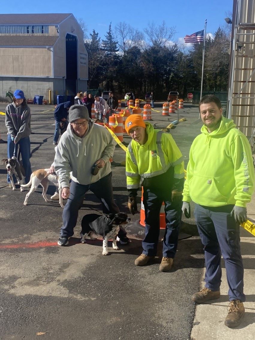 People outdoors waiting for dog rabies shots